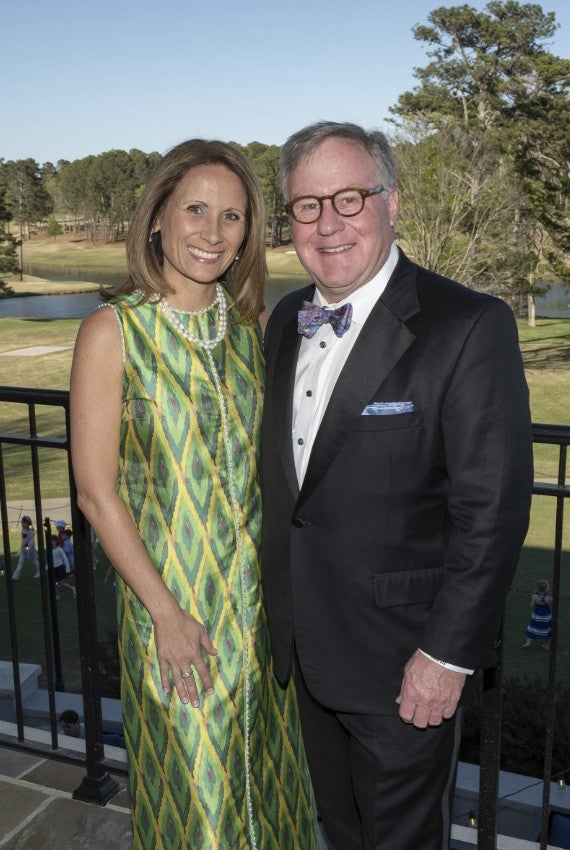 Man and woman dressed elegantly and holding one another in a side hug.  (Photo Credit: Wingate Downs)