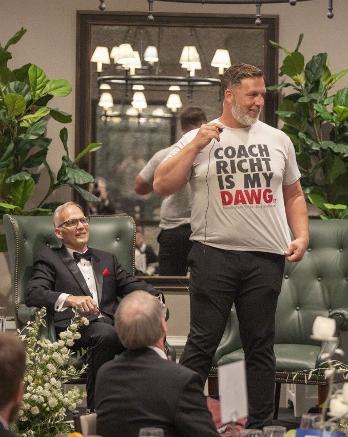 Man showing off t-shirt on stage which states: "Coach Richt is my dawg." (Photo Credit: Wingate Downs)