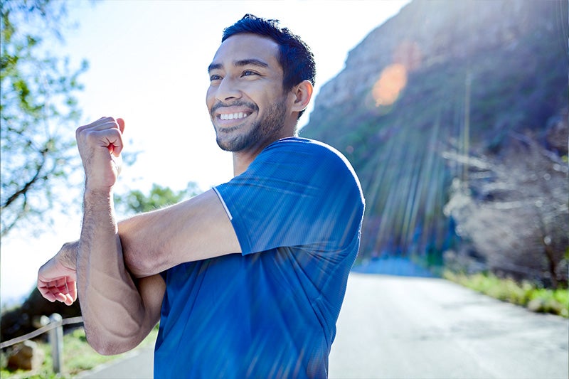 Man with ADHD stretching after a run.