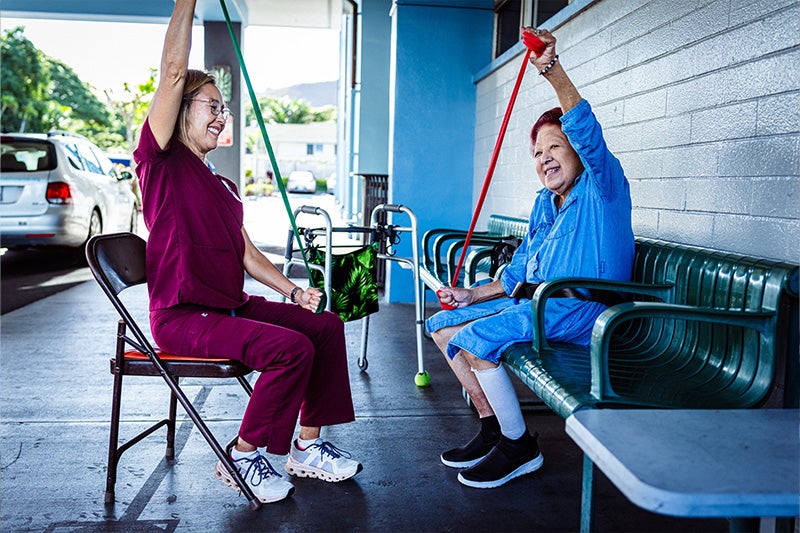 Physical therapist helping a patient with their rehabilitative therapy.