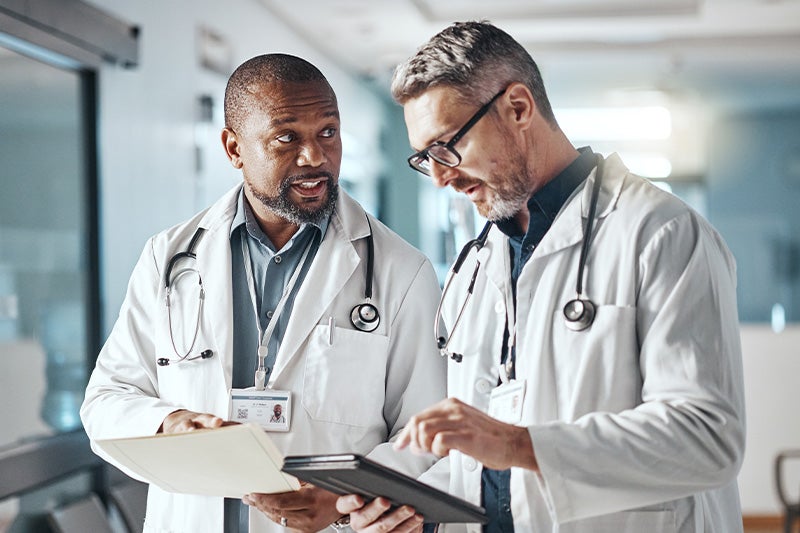 Two doctors talking in a hallway after a wellness exam.