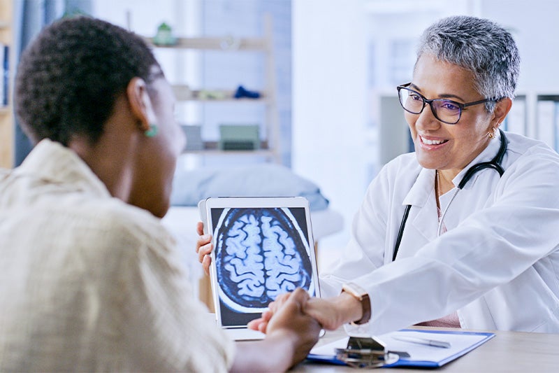 Neurosurgeon speaking with a patient about an upcoming surgery.