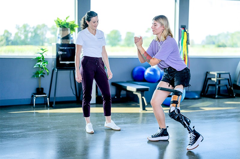 Physical therapist assisting a patient with Amputee Rehabilitation.