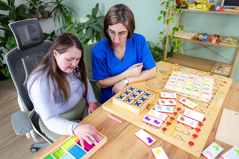 Cognitive Rehabilitation Therapist assisting a patient with therapy activities.