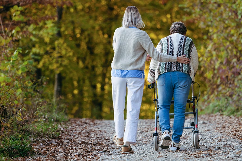 Nurse assisting a patient recovering from a fall injury with walking.
