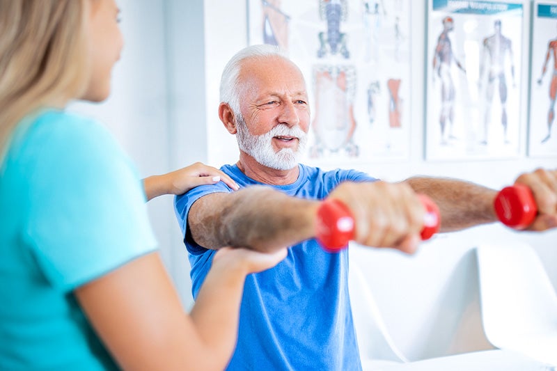 Patient working on strength training exercises with a personal trainer.