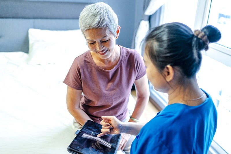 Physician explaining results of bone density scan to patient.