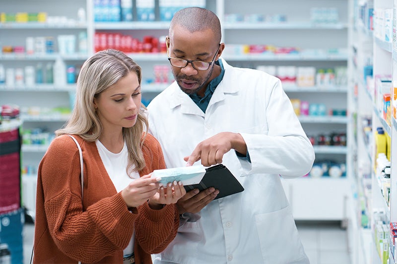 St. Mary's Community Pharmacy Pharmacist assisting a patient with medication education.