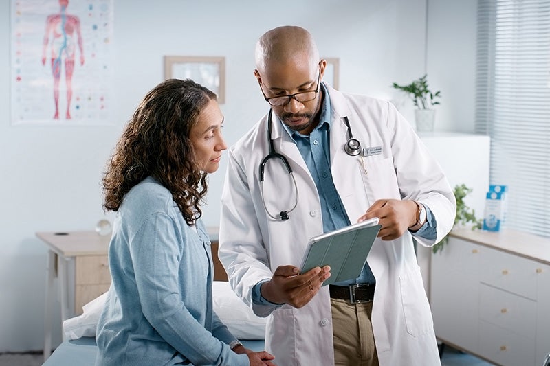 Physician discussing the importance of limiting tobacco use with patient.
