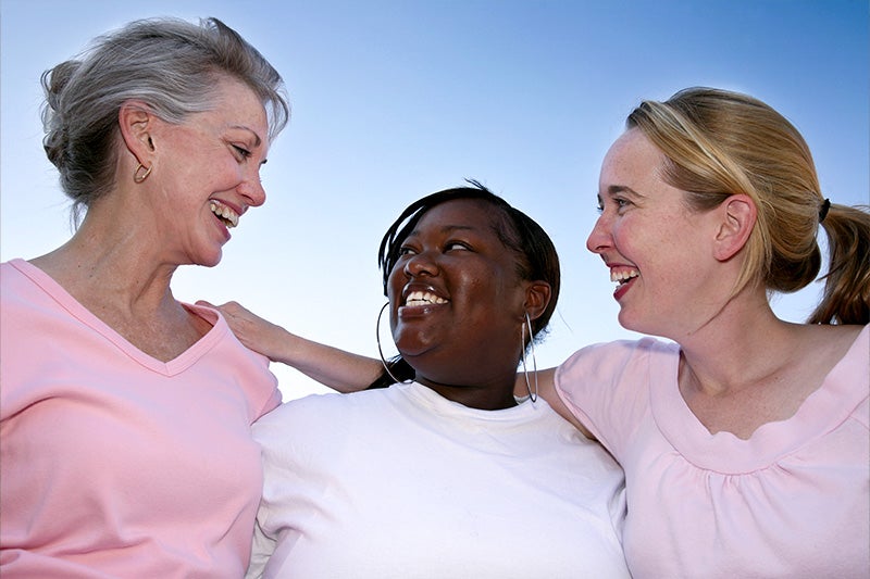 Women smiling and laughing during a walk.