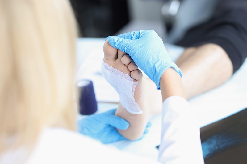 Patient caring for a foot wound of a wound care patient.