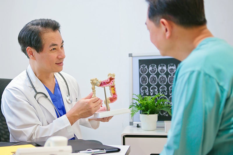 Colorectal surgeon discussing a laparoscopic surgery with a patient.