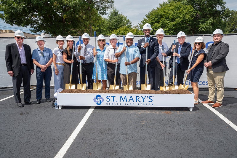 St. Mary's Leadership Team holding shovels and posing for a photo during groundbreaking ceremony.