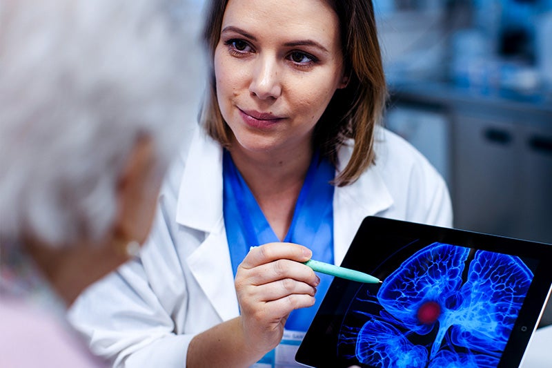 Physician speaking to a patient about the results of their neurological scan.