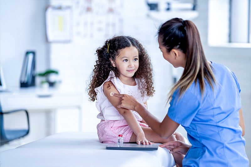 Child and pediatrician in a physician's office.