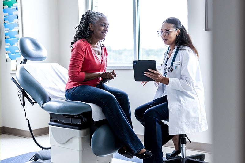 Female patient speaking to a physician about allergy symptoms.