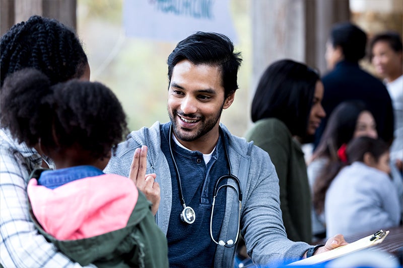 Parent and child visiting with a Primary Care Provider.