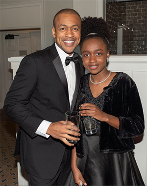 Photo of Dr. Patrick Willis and his daughter, smiling at the camera.