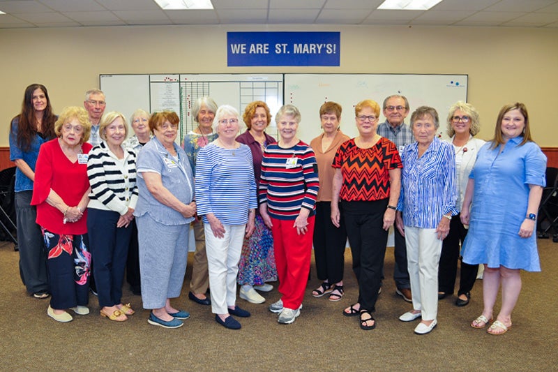 Many of St. Mary’s Upscale Thrift Store volunteers pose for a photo at a May 8 celebration honoring them and the store's 19th anniversary