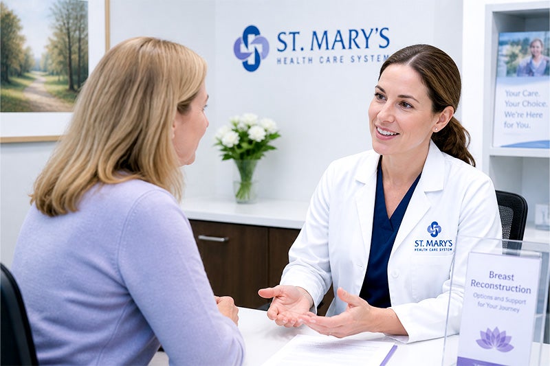 Surgeon discussing breast reconstruction surgery with a female patient.