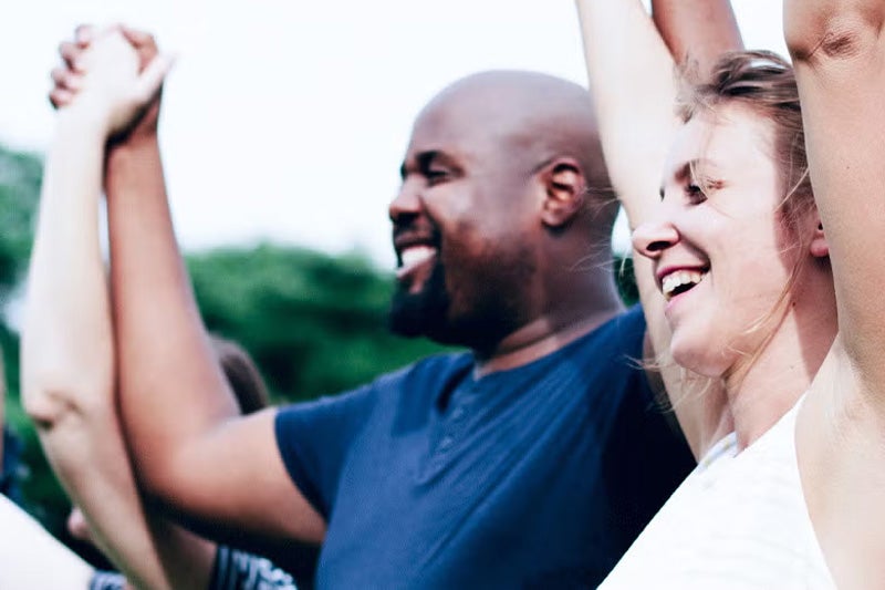 People holding hands in excitement