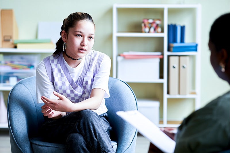 Teenager with Autism speaking with a therapist.